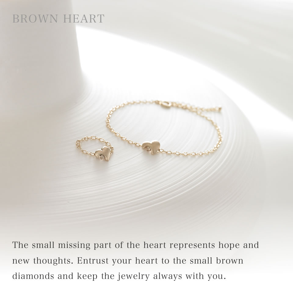 The small missing part of the heart represents hope and new thoughts. Entrust your heart to the small brown diamonds and keep the jewelry always with you.
